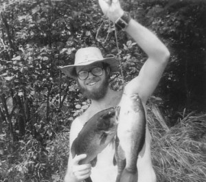Portrait of the Angler As a Young Man holding Lost Lake Bass